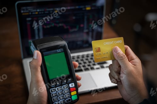 Preview: Man hands holding credit card and using laptop or smart phone Online shopping Website.