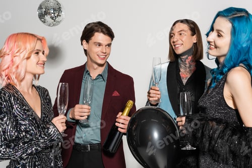 Preview: smiling nonbinary person with blue hair and black balloon celebrating christmas with queer friends
