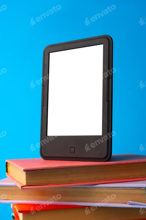 Preview: Modern e-book on stack of hardcover books on blue background