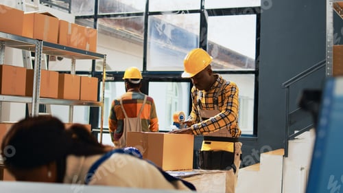 Preview: African american men packing products in boxes