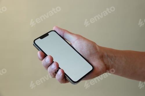 Preview: Man with modern smartphone on grey background, closeup. Mockup for design