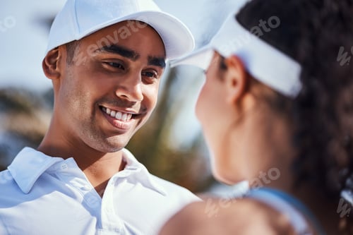 Preview: Shot of a young couple standing together during a game of tennis