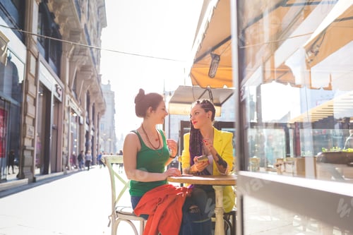 Preview: Women on city break at outdoor cafe, Milan, Italy