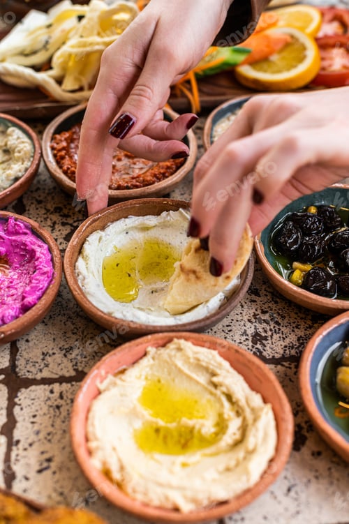Preview: Women eating Traditional Turkish Village Breakfast served in restaurant. Top view