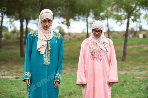 Preview: Muslim women praying outdoors wearing traditional djellabas