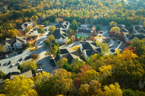 Preview: View from above of apartment residential condos between yellow fall trees