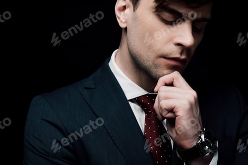 Preview: thoughtful businessman with closed eyes holding hand near face isolated on black