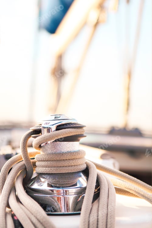 Preview: Sailboat detailed parts. Close up on winch and rope of yacht over blue sea. Yachting concept. Shallo