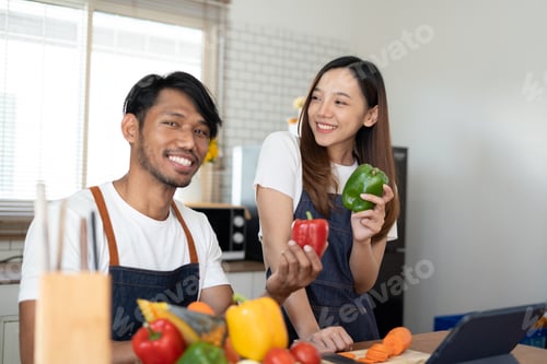 Preview: Couple cooking together. Happy young couple cooking together in the kitchen. valentine day concept.