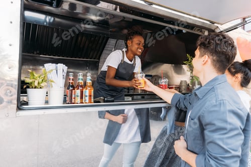 Preview: Young entrepreneur working in her a food truck