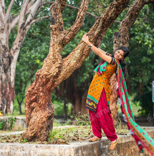Preview: Young girl near tree trunk and she enjoying fresh air outdoors