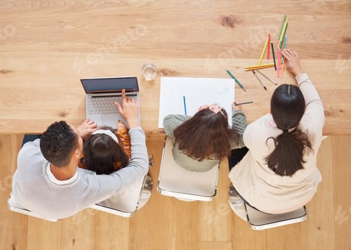Preview: Helping our children grow. Shot of two parents helping their children with their homework.