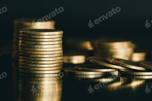 Preview: close up stack of golden money coin on black background with selective focus.