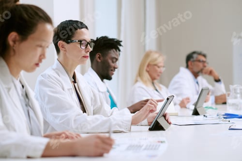 Preview: Multiethnic Group of Middle Aged Medical Professionals Using Digital Tablets