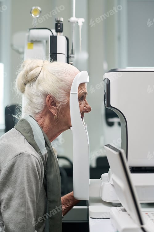 Preview: Senior Woman Undergoing Eye Examination Using Medical Equipment