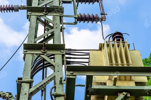 Preview: Green electric pole with a transformer standing next to railway tracks, used to