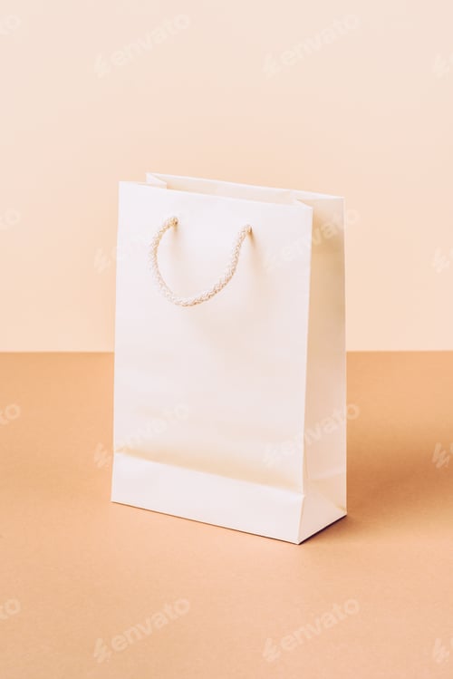 Preview: white paper shopping bag on beige