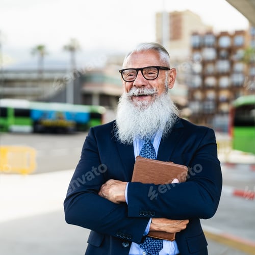 Preview: Happy senior business man holding laptop while waiting in bus station