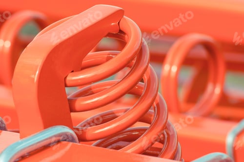 Preview: Hard red spring made of steel. Part of big industrial or agricultural machine