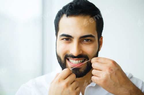 Preview: Dental Health. Man With Beautiful Smile Flossing Healthy Teeth. High Resolution Image