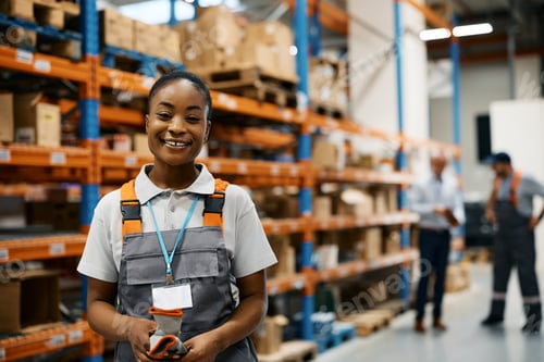 Preview: Happy black female worker at distribution warehouse looking at camera.