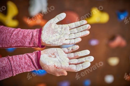 Preview: hands with liquid bouldering chalk over blured climbing wall background