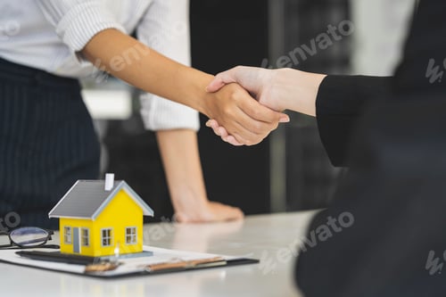 Preview: Successful deal Real estate lease or home purchase concept buyer shakes hands with bank employee aft