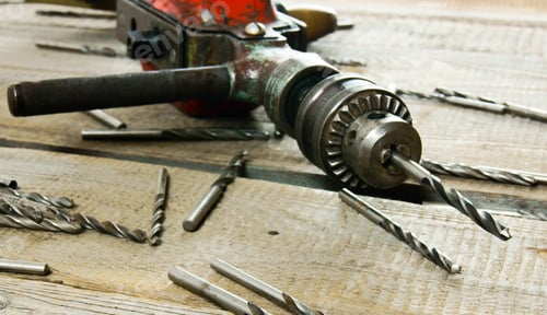 Preview: drill on wooden background.