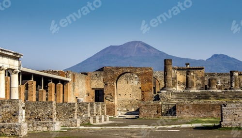 Preview: Beautiful shot of a historical building with high mountains in the background under the blue sky
