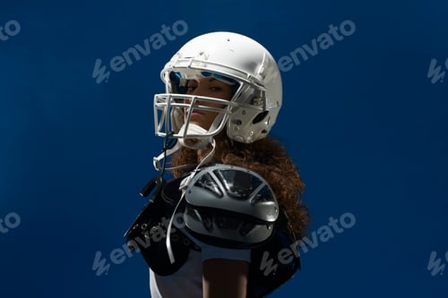 Preview: Portrait of female american footballer wearing helmet