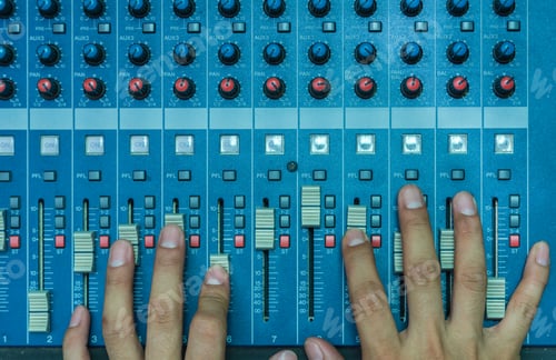 Preview: Top view of Hands adjusting audio mixer, music instrument concept