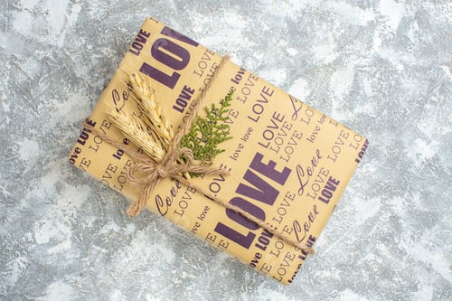Preview: Overhead view of beautiful Christmas big packed gift on ice background