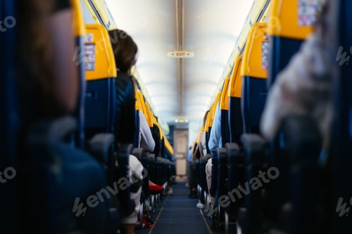 Preview: Selective focus shot of a crowded airplane aisle