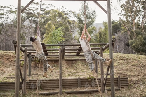 Preview: Military soldiers climbing rope during obstacle course training