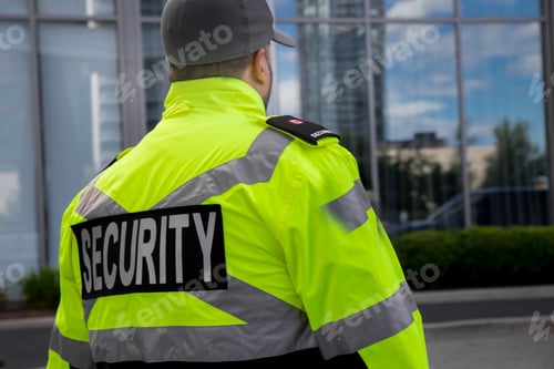Preview: Security guard in uniform patrolling a residential area.