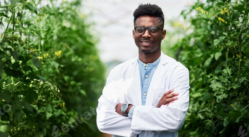 Preview: Portrait of a handsome young botanist posing with his arms folded outdoors in nature