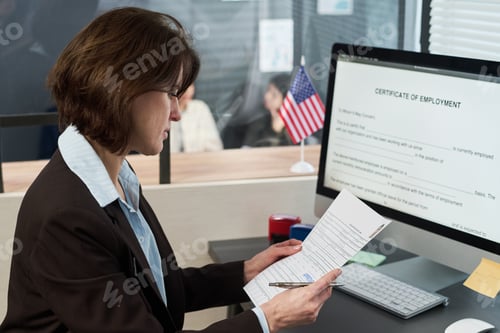 Preview: Middle Aged Woman Reviewing Documents at Visa Center Office Desk