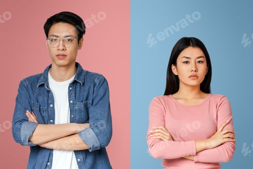 Preview: Upset asian man and woman posing over grey background