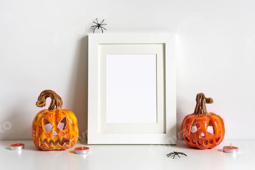 Preview: Halloween composition with ceramic pumpkins jack lantern and frame on table wall background
