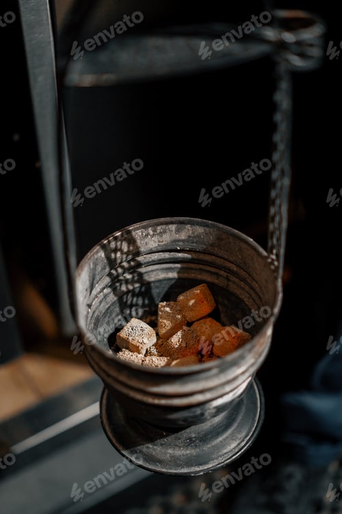 Preview: Heating coals for hookah Fire and smoke Relax and lounge concepts preparing coal for smoking hookah