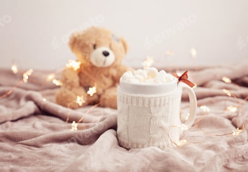 Preview: Hot chocolate with marshmallows on soft plaid background with Christmas lights. Perfect winter time