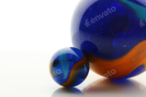 Preview: Closeup shot of two big and small balls with colorful textures on a white surface