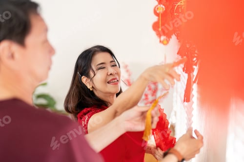 Preview: Elderly couple celebrating chinese new year home setting joyful decorations intimate environment