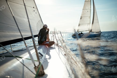 Preview: Young handsome man relaxing on his sailboat