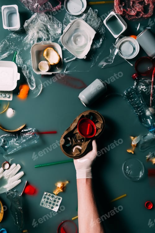 Preview: partial view of man in latex glove cleaning water from trash, ecology protection concept