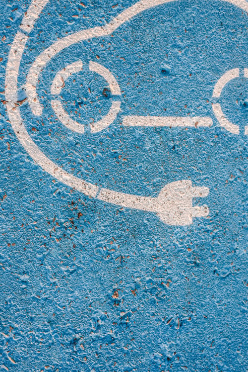 Preview: Electric cars. Sign painted on the floor of a parking lot for electric recharging station.
