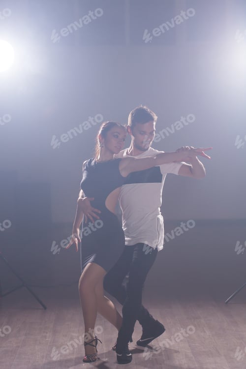 Preview: Active happy adults dancing bachata together in dance class