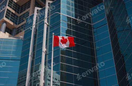 Preview: Flag of Canada flying against a blue sky.
