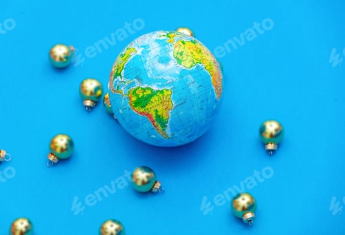 Preview: Silver baubles and globe on blue background, side view