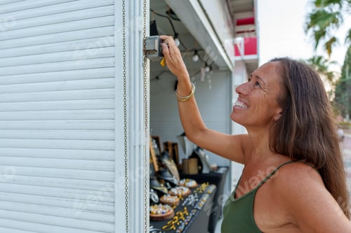 Preview: Hispanic Woman in Her 50s Opening Her Street Stall to Sell Handmade Jewelry Crafted with Aluminum